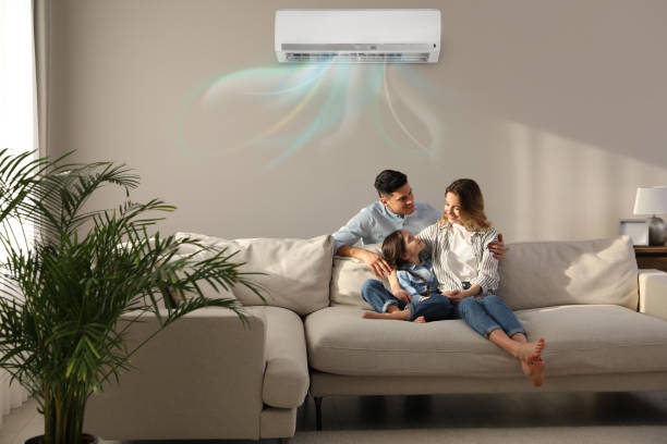 A family relaxing in a living room with wall-mounted air conditioning