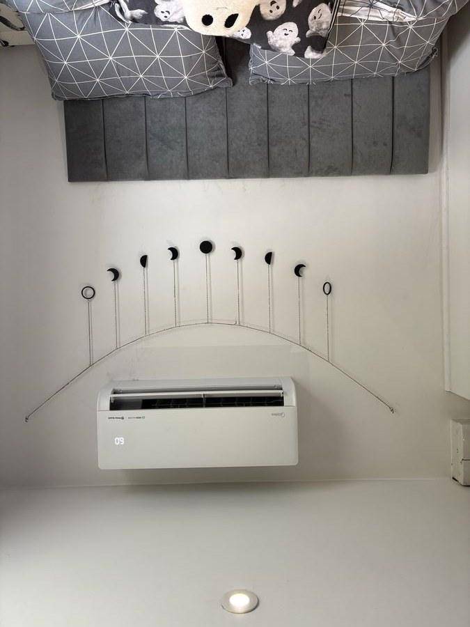 Midea air conditioning indoor unit installed above bed
