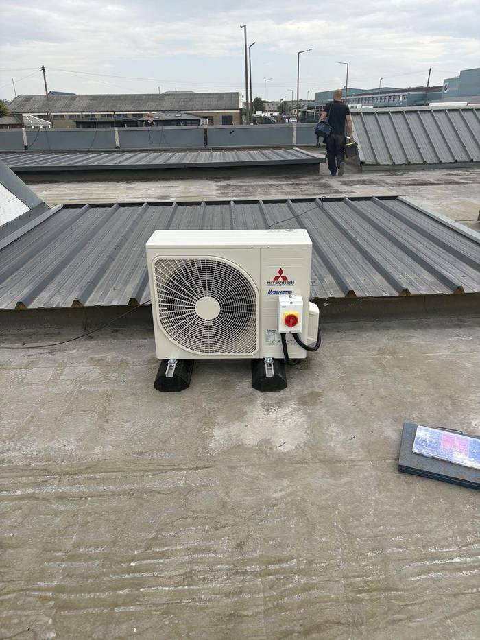 Mitsubishi Heavy Industries air conditioning outdoor unit installed on commercial flat roof